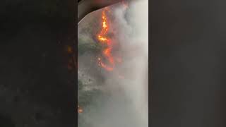 Bell 214st Fire Fighting Helicopter Flying Over the Fire