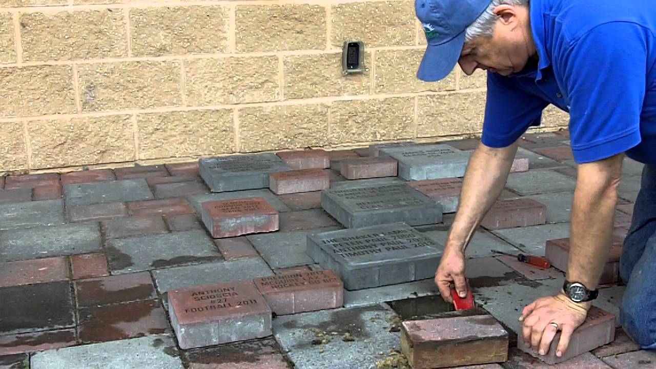 masonry contractor replacing brick pavers in driveway