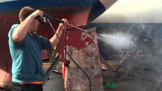 DIY Boat Restoration: Jet washing boat to remove anti-foul paint