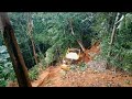 This crazy d6r xl bulldozer works cutting hills in times of heavy rain to make new roads