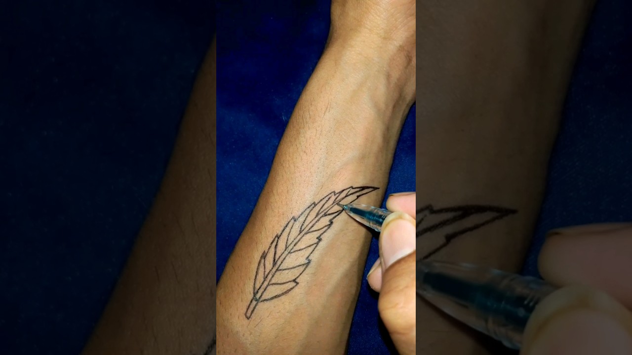 green leaf design tattoo on hand with pen 