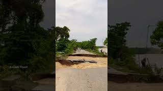 A damaged road due to flooding after heavy rains in Assam, India