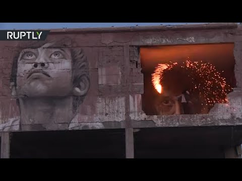 Palestinian children celebrate over the rubble of refugee camp using handmade fireworks