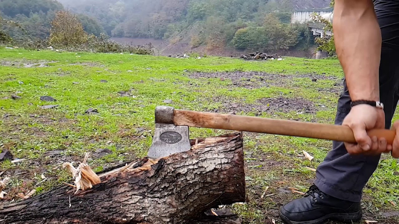 How to Cut a Big Log with an Ax - YouTube