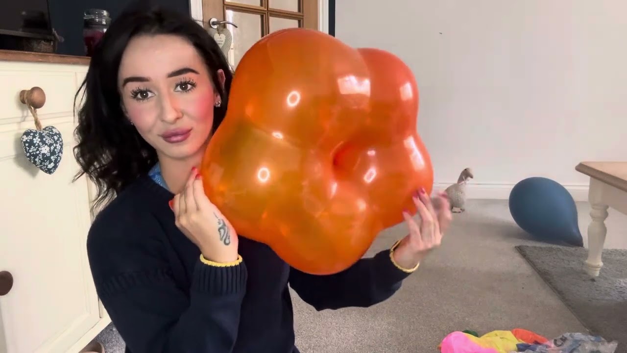 Blowing up an orange geo blossom balloon and deflating