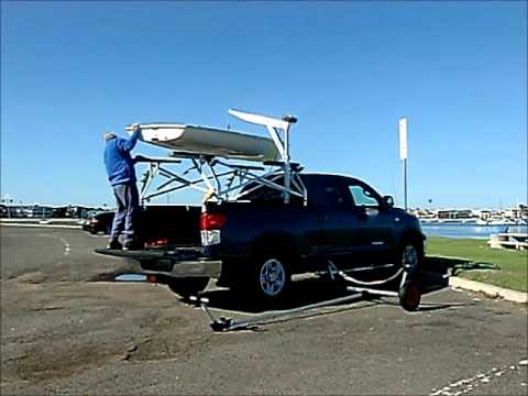 laser sailboat on top of car