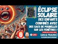 Clipse solaire  des enfants confins avec des sacs de poubelles sur les fentres 