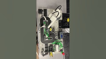 VEX CTE workcell sorting custom color pucks and placing in a custom holder wall.