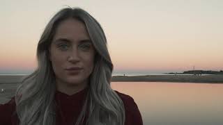 Young Woman on the Beach Looking into Camera - HIGH ULTRA 4K Stock Footage screenshot 3