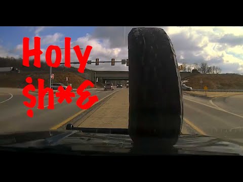 Holy $*&$, wheel flies through a windshield caught on camera