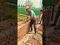 arranging bricks neatly with cement mortar to build a sturdy and well structured building wall