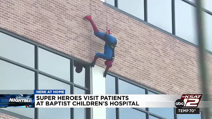 Superheroes rappel down Baptist Children's Hospita...