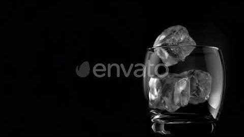 Ice cubes falling in super slow motion in a glass | Stock Footage - Envato elements