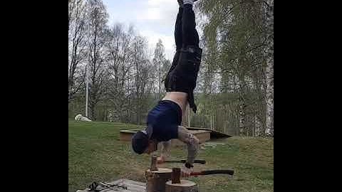 Guy Performs Handstand Push Ups While Balancing Himself Over Two Axes - 1199477