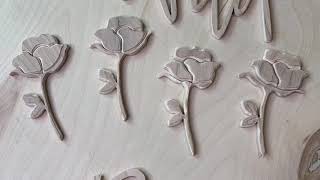 Cut flowers with scroll saw to create wooden signs