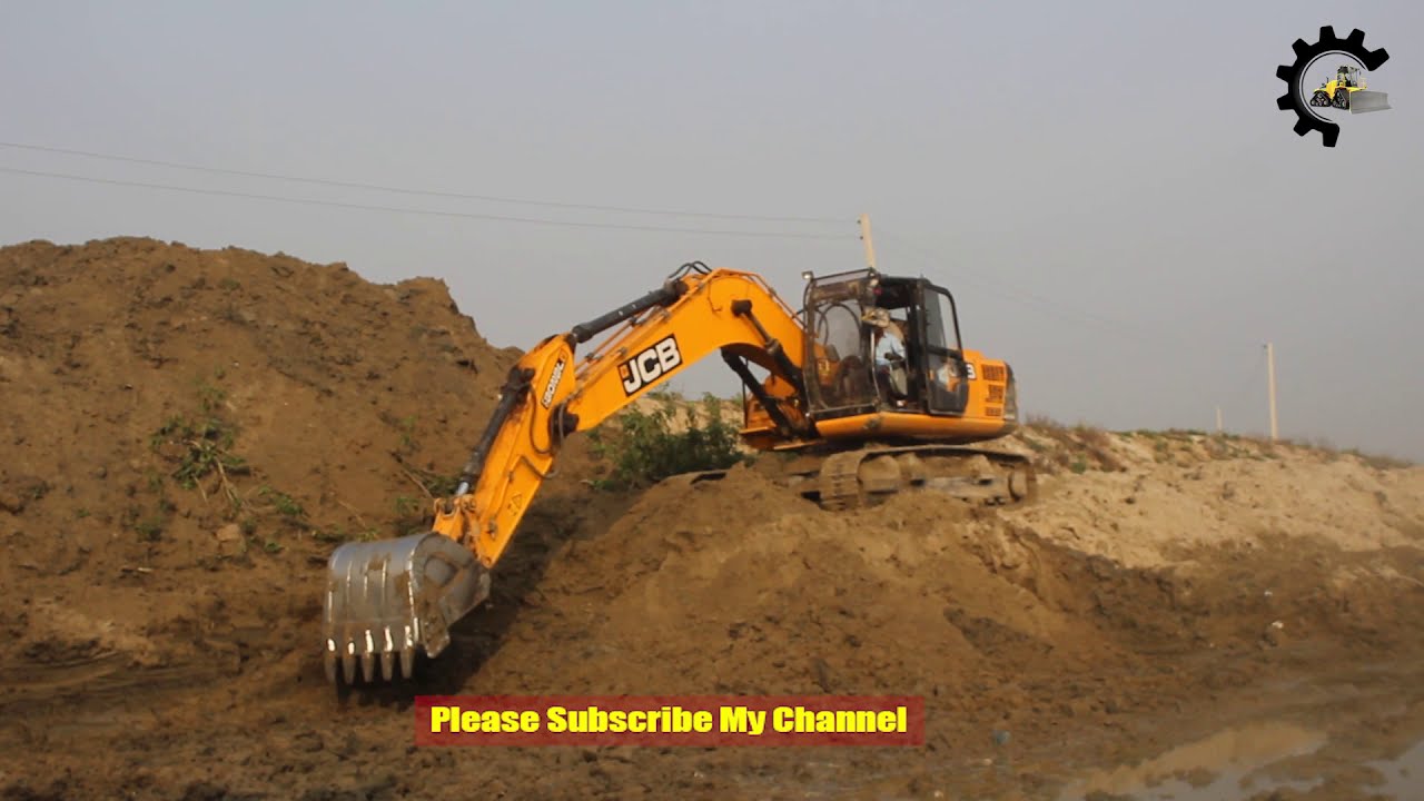Jcb Excavator making dam in river side - jcb excavator collecting solid mud
