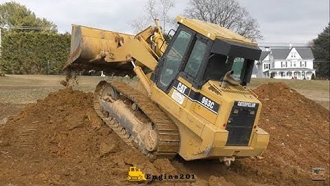 CAT 963C In the Beginning Stages of Digging Out a Basement