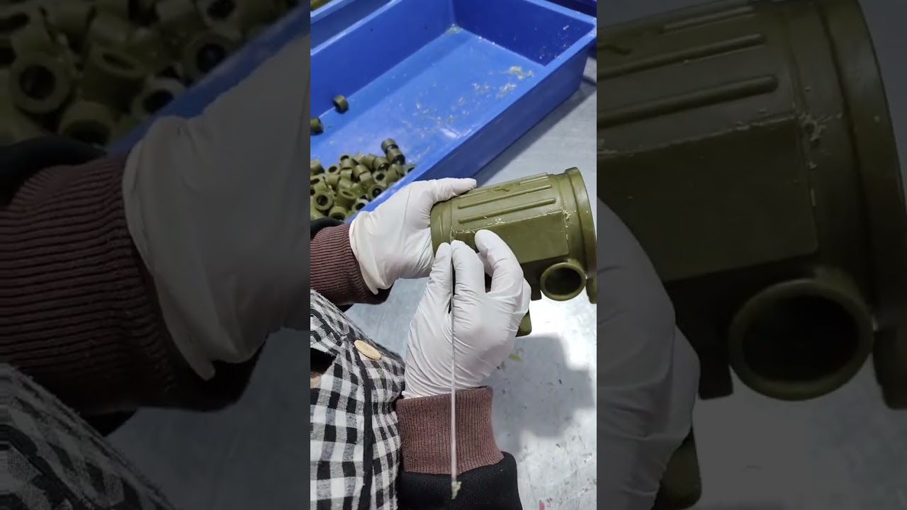 Workers are carefully grinding the burrs on the mold 