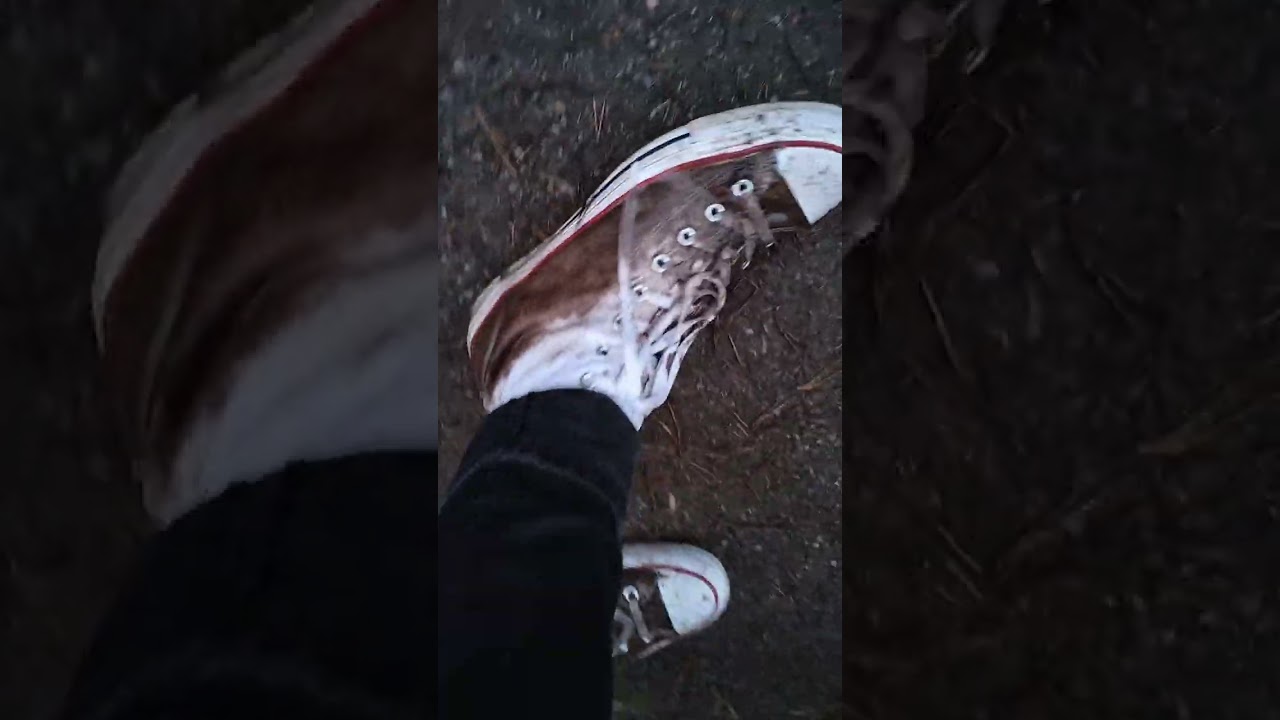 White high top Converse in the mud