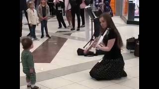 Violinist playing for baby at ATL airport