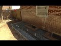 Concrete and Channel Drain installed against foundation to solve stubborn basement flooding