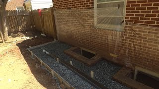 Concrete and Channel Drain installed against foundation to solve stubborn basement flooding