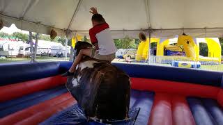 Dominic Dolla rides a mechanical bull at the county fair 2019