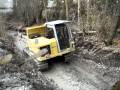 Komatsu in Creekbed mud.