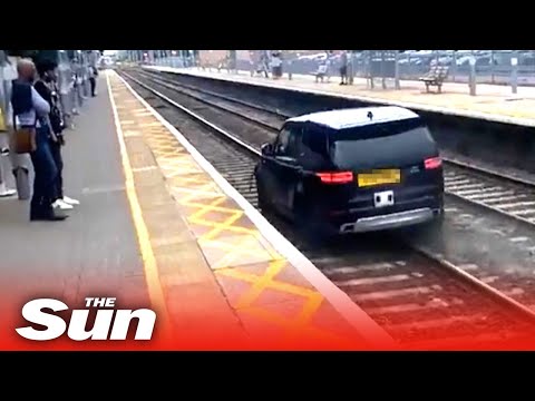 Car chase sees moron drive along TRAIN TRACKS as cops pursue in disbelief.