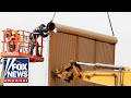 Critics sound alarm after video shows men climbing Trump's border wall