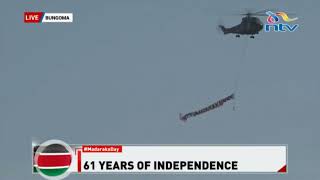 A military chopper flies over Masinde Muliro stadium with a banner written Happy Madaraka day