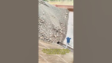 Workers Unloading Cobblestones with Poles
