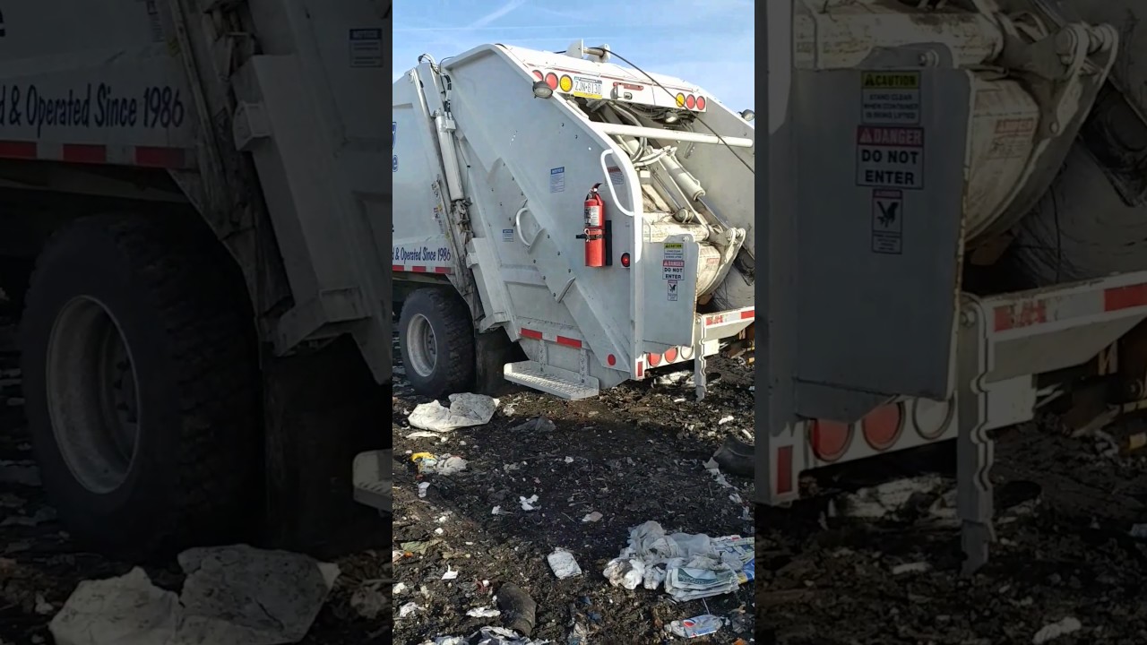 Rear loading garbage truck emptying 16000lbs