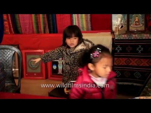 Cute young Bhutanese girls - one puts scissors in her mouth