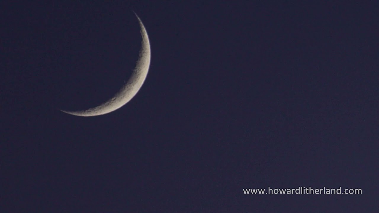 Time lapse of a crescent moon setting in a darkening sky