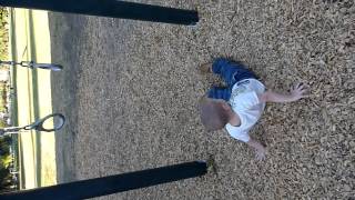 Little William Doing Flips On The Trapeze Rings At The Playground