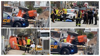 Construction Accident! worker seriously injured after a Boom Lift topples off a flatbed truck 