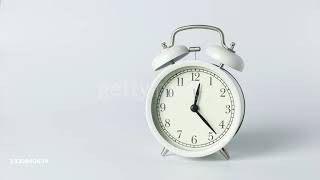 White alarm clock retro style for waking up on the white background, studio shot. - 4K stock video