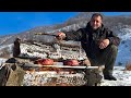 Roasted two really huge and juicy steaks among the mountains using a chopped log