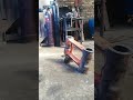 SWINGING AND BANGING WITH HEAVY MANUAL HAMMER IN REPAIRING EXCAVATOR'S END BOSS