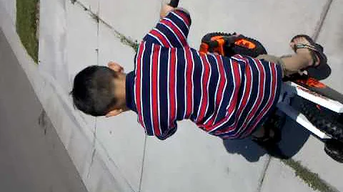 Nicholas. Riding his bike...