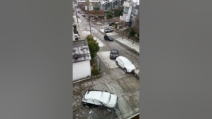 Car slides and crash down icy Seattle hill