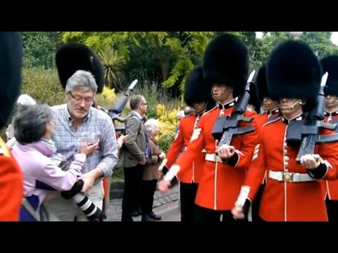 Queens guards trample tourists