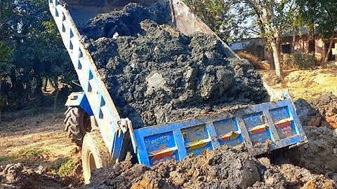 Clay is load from the river into tractors & unloading over rough road through hydraulic facilities||