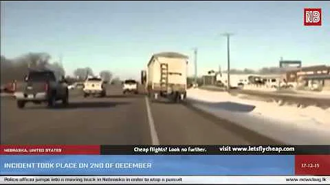 Police officer jumps into a moving truck in Nebraska