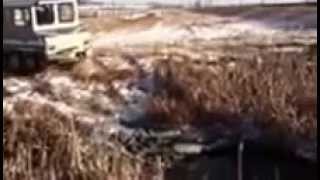 Bombardier J5 Tracked Unit Going Into Open Mud Hole.