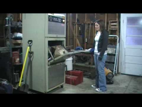Girl smashes boxes in a compactor