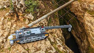 LEGO Technic crane explores deep chasm cave entrance.