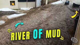 River of Mud Passing by Houses
