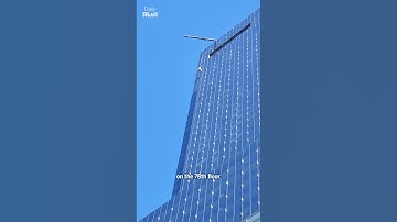 Window washers dangle from broken scaffold